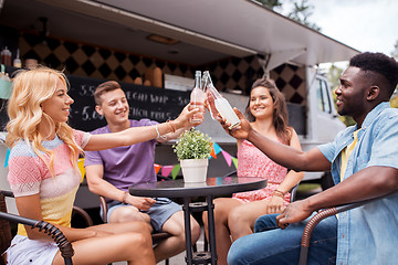 Image showing friends clinking bottles with drinks at food truck