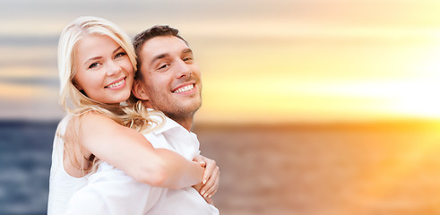 Image showing happy couple hugging over sea background