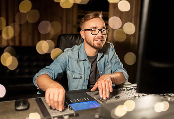 Image showing man at mixing console in music recording studio