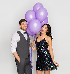 Image showing happy couple with ultra violet balloons at party