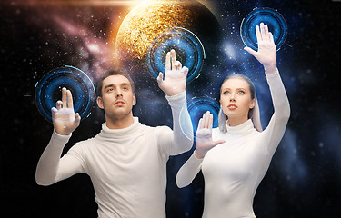 Image showing couple using touch screen over space background