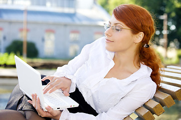 Image showing businesswoman with laptop in the park