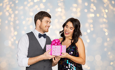 Image showing happy couple with gift box at birthday party