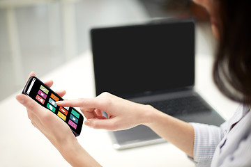 Image showing close up of woman with icons on smartphone screen