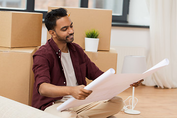 Image showing man with blueprint and boxes moving to new home