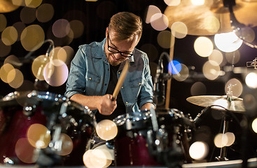 Image showing male musician playing drums and cymbals at concert