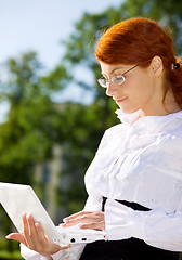 Image showing businesswoman with laptop in the park