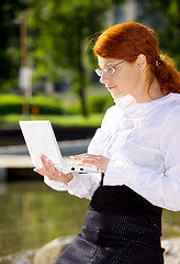 Image showing businesswoman with laptop in the park