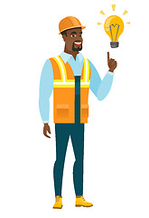 Image showing Builder pointing at bright idea light bulb.