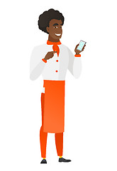 Image showing African-american chef cook holding a mobile phone.