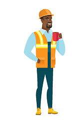 Image showing African-american builder holding cup of coffee.