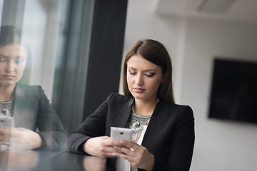 Image showing Business Girl Standing In A Modern Building Near The Window With