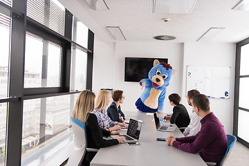 Image showing boss dresed as bear having fun with business people in trendy of