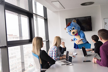 Image showing boss dresed as bear having fun with business people in trendy of