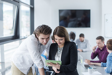 Image showing Two Business People Working With Tablet in office