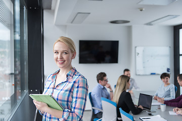 Image showing Pretty Businesswoman Using Tablet In Office Building by window