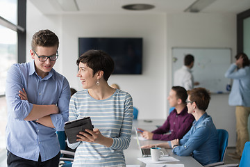 Image showing Two Business People Working With Tablet in office