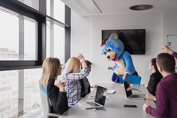 Image showing boss dresed as bear having fun with business people in trendy of