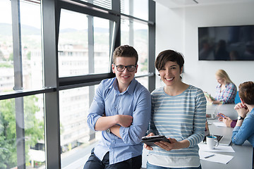 Image showing Two Business People Working With Tablet in office