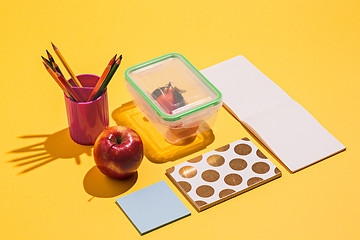 Image showing Photo of office and student gear over yellow background