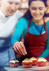 Image showing happy woman and chef cook baking in kitchen