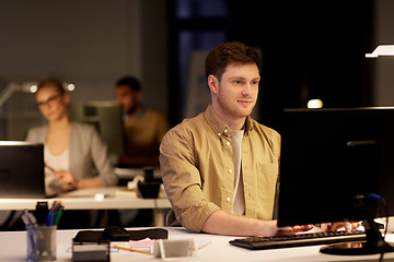 Image showing man with computer working late at night office