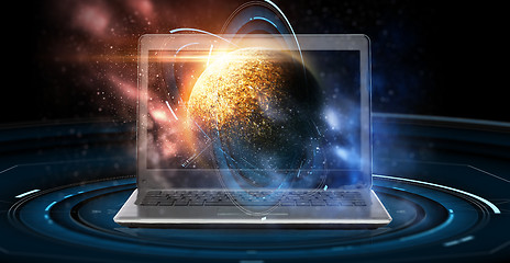 Image showing laptop with virtual planet and space hologram