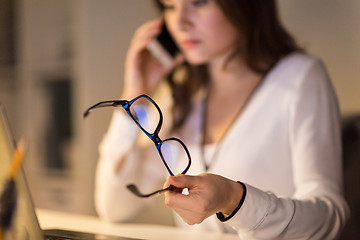 Image showing woman with eyeglasses calling on smartphone