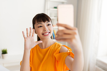 Image showing happy asian woman taking selfie by smartphone