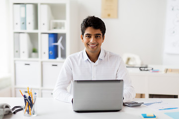 Image showing businessman with laptop and papers at office