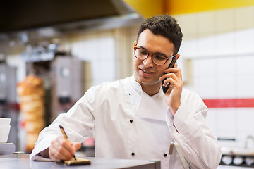 Image showing chef at kebab shop calling on smartphone