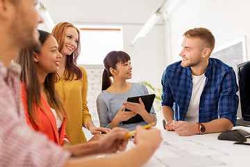 Image showing creative team with blueprint working at office