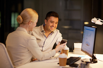 Image showing business people with smartphone at night office