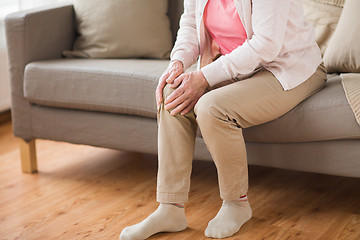 Image showing close up of senior woman with pain in leg at home