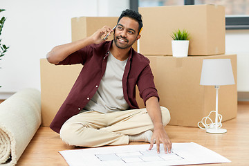 Image showing man moving to new home and calling on smartphone