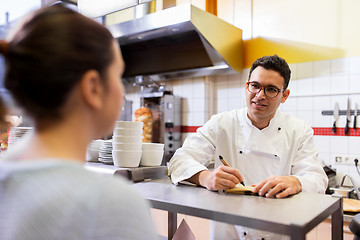 Image showing chef at fast food restaurant writing order