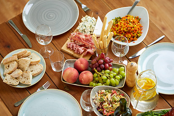 Image showing various food on served wooden table