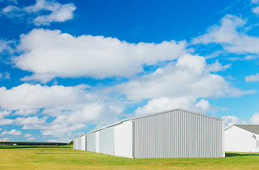 Image showing Metallic warehouse with blue sky