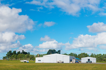 Image showing Metallic warehouse with blue sky