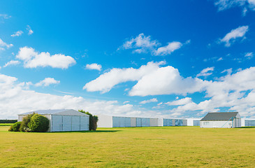 Image showing Metallic warehouse with blue sky