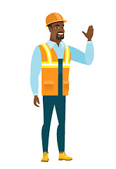 Image showing Young african-american builder waving his hand.