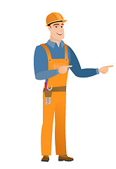 Image showing Young caucasian builder pointing to the side.