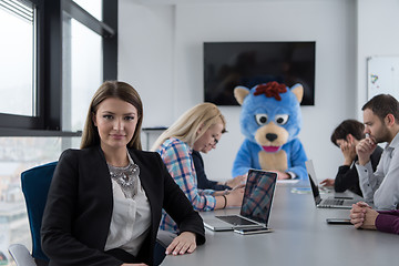 Image showing boss dresed as bear having fun with business people in trendy of