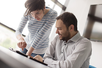 Image showing Two Business People Working With Tablet in startup office