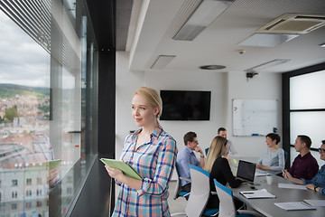 Image showing Pretty Businesswoman Using Tablet In Office Building by window