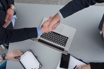 Image showing cloasing the deal in modern office interior top view