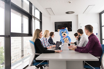 Image showing boss dresed as bear having fun with business people in trendy of