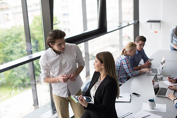 Image showing Two Business People Working With Tablet in office