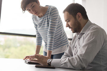 Image showing Two Business People Working With Tablet in startup office