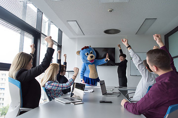 Image showing boss dresed as bear having fun with business people in trendy of